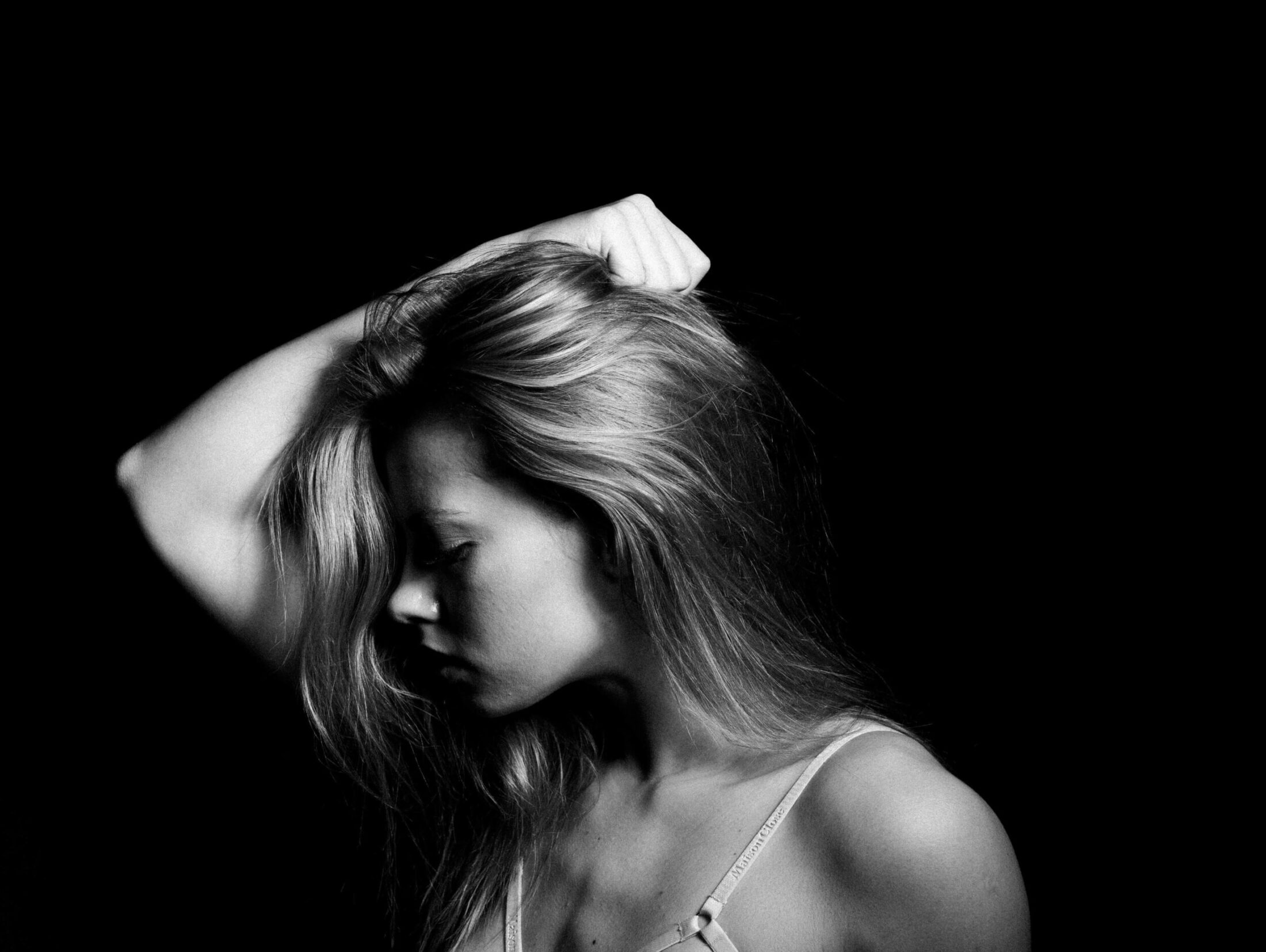 Dramatic black and white portrait of a blonde woman.